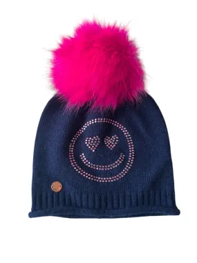 Navy cashmere plain knit beanie with a pink smiley embellishment & faux fur pom