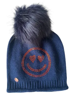 Navy cashmere plain knit beanie with an orange smiley embellishment & faux fur pom