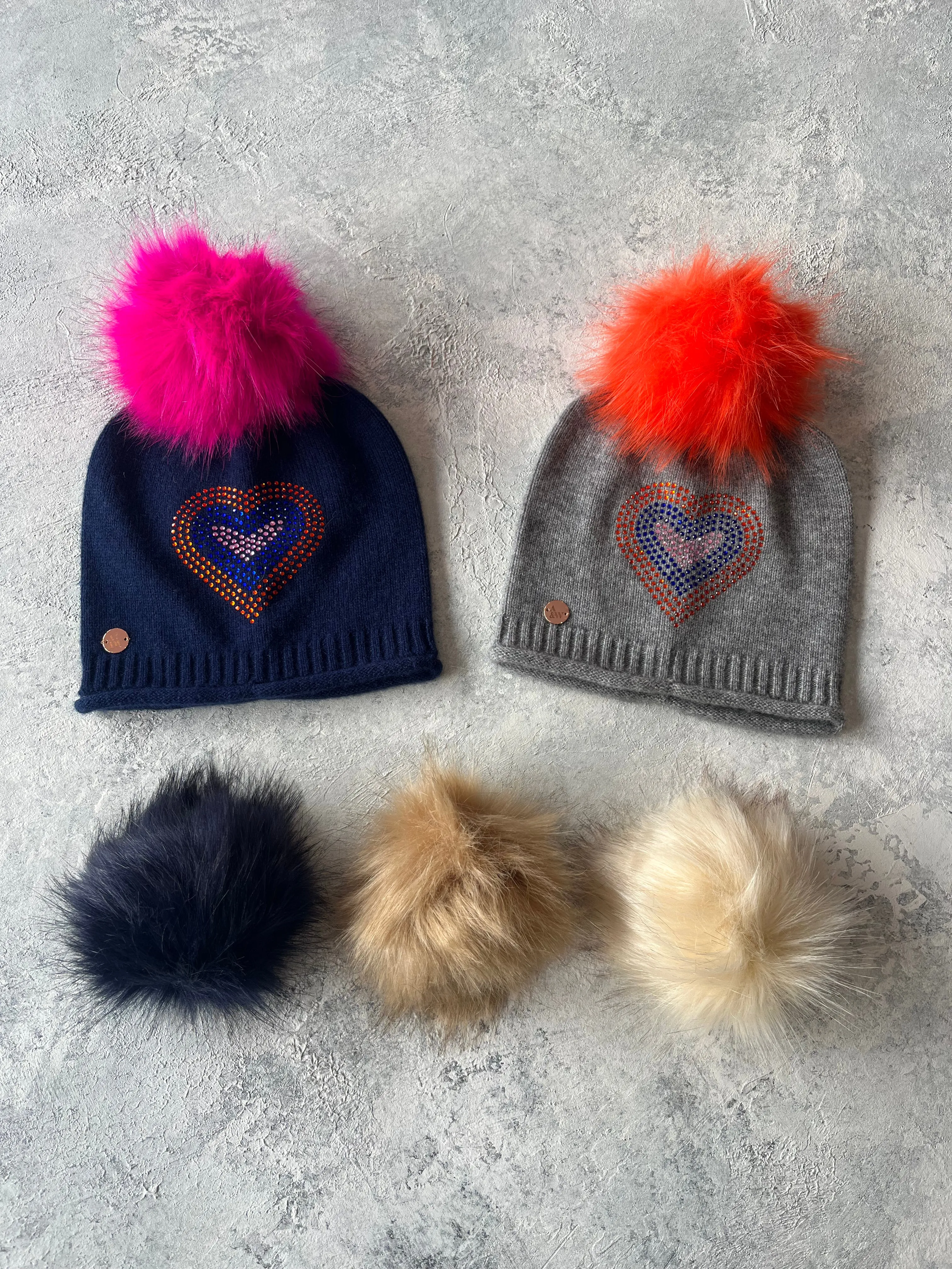 Navy cashmere plain knit beanie with heart embellishment & faux fur pom